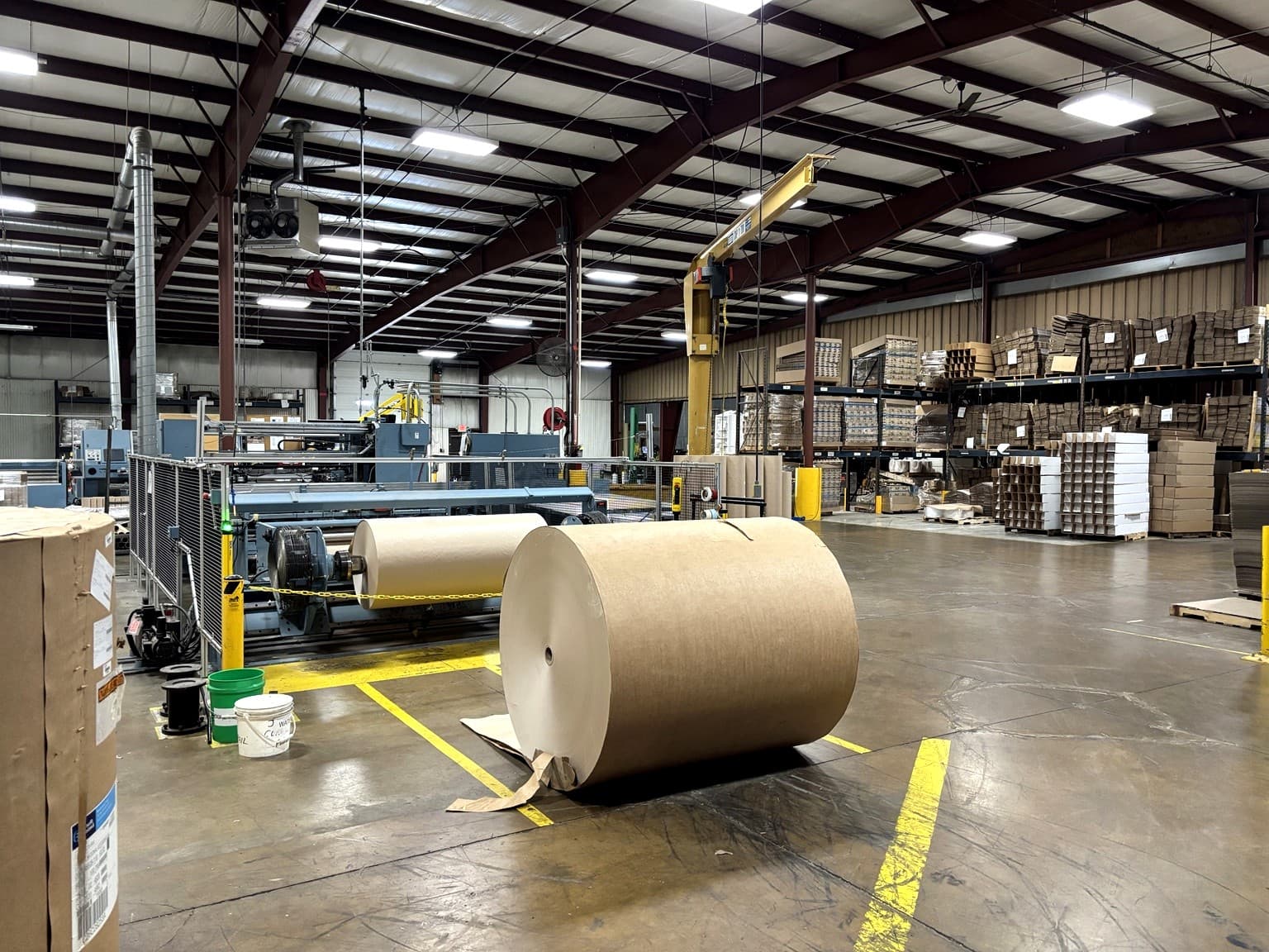 Wide view of the Paper Dimensions production floor in Beaver Dam, Wisconsin, showing the five rewinder/slitters used for custom paper converting