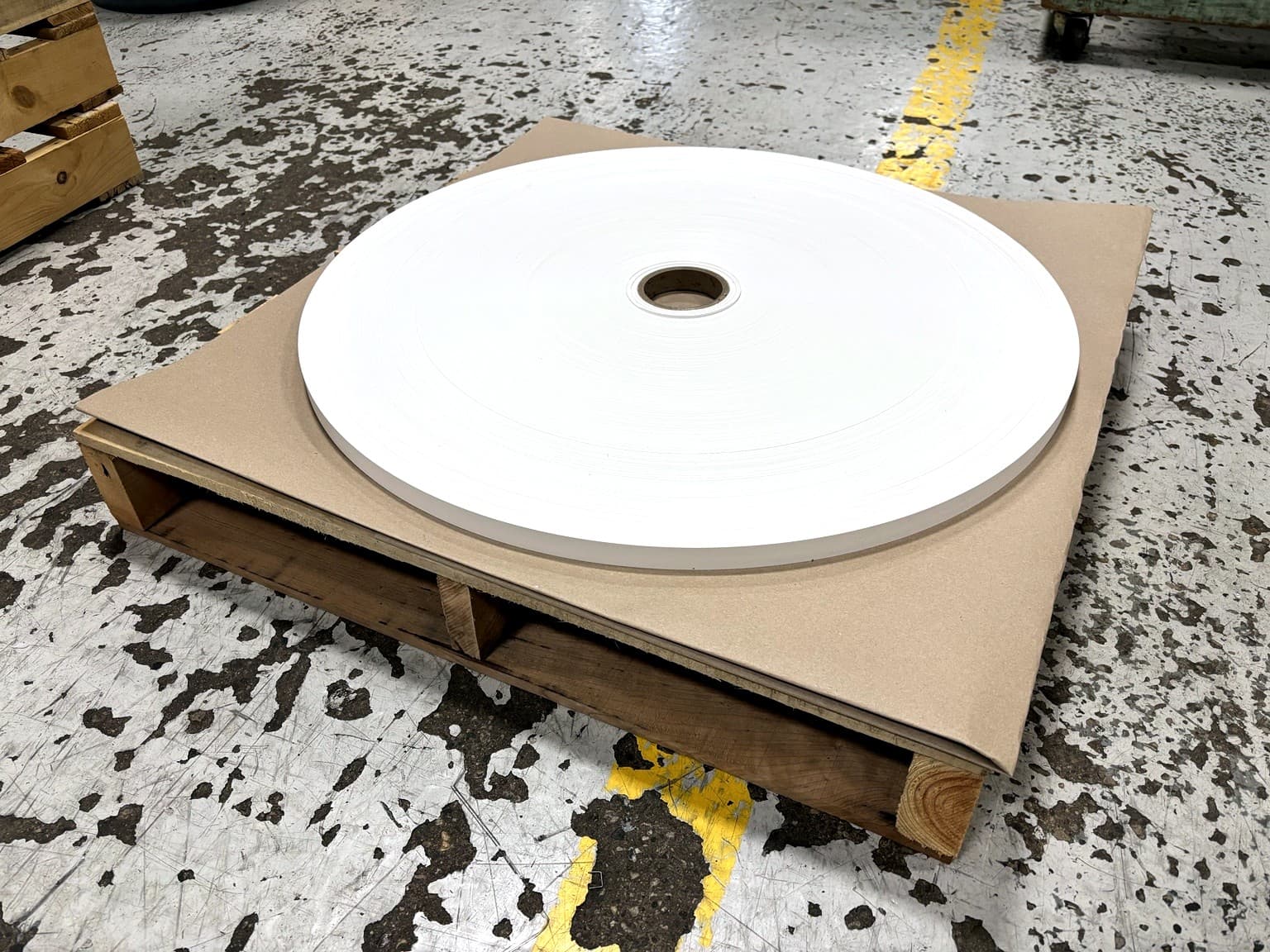 Finished slit paper roll palletized and ready for pickup at Paper Dimensions
