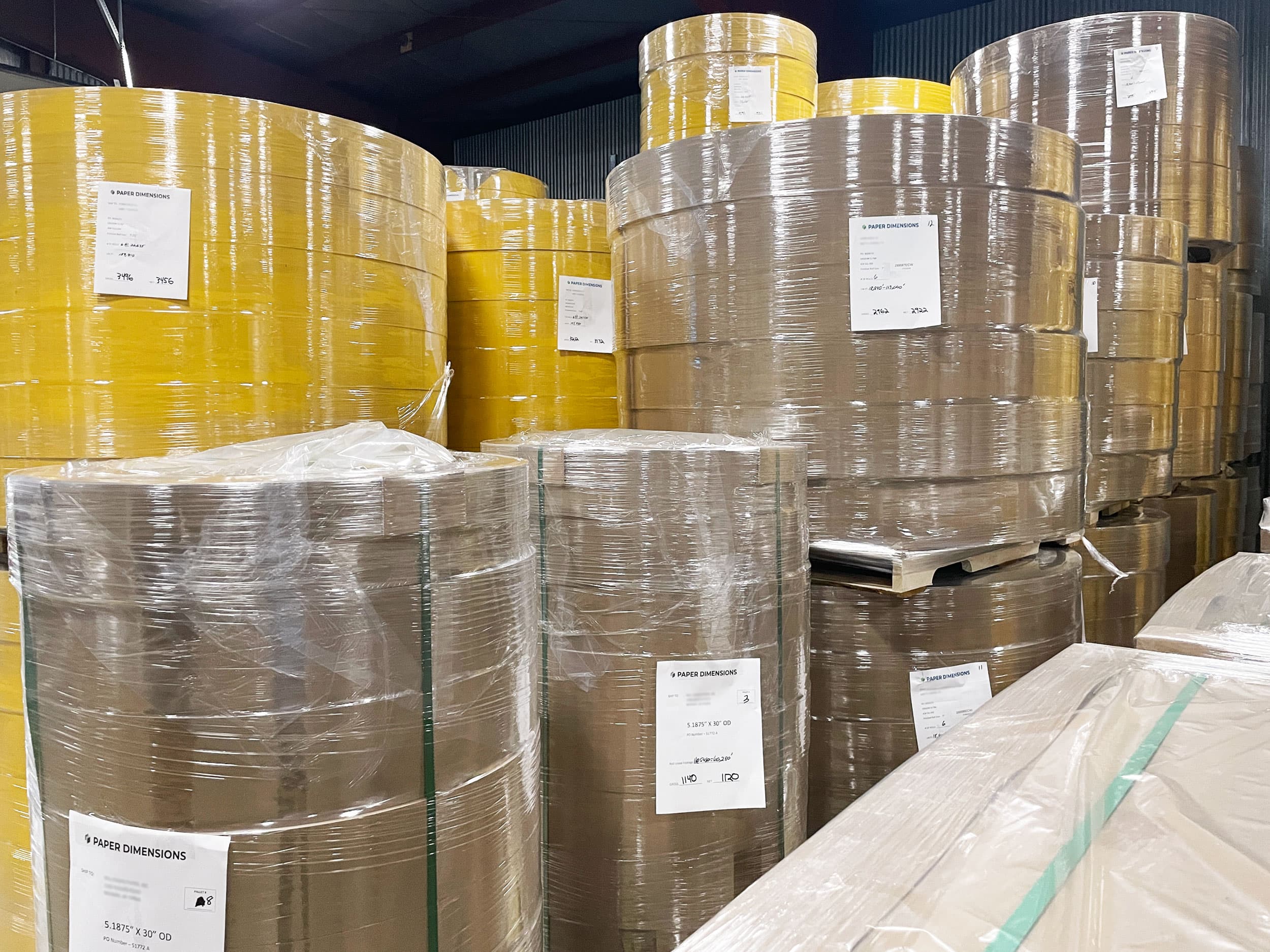 Wrapped and palletized finished paper rolls staged at Paper Dimensions