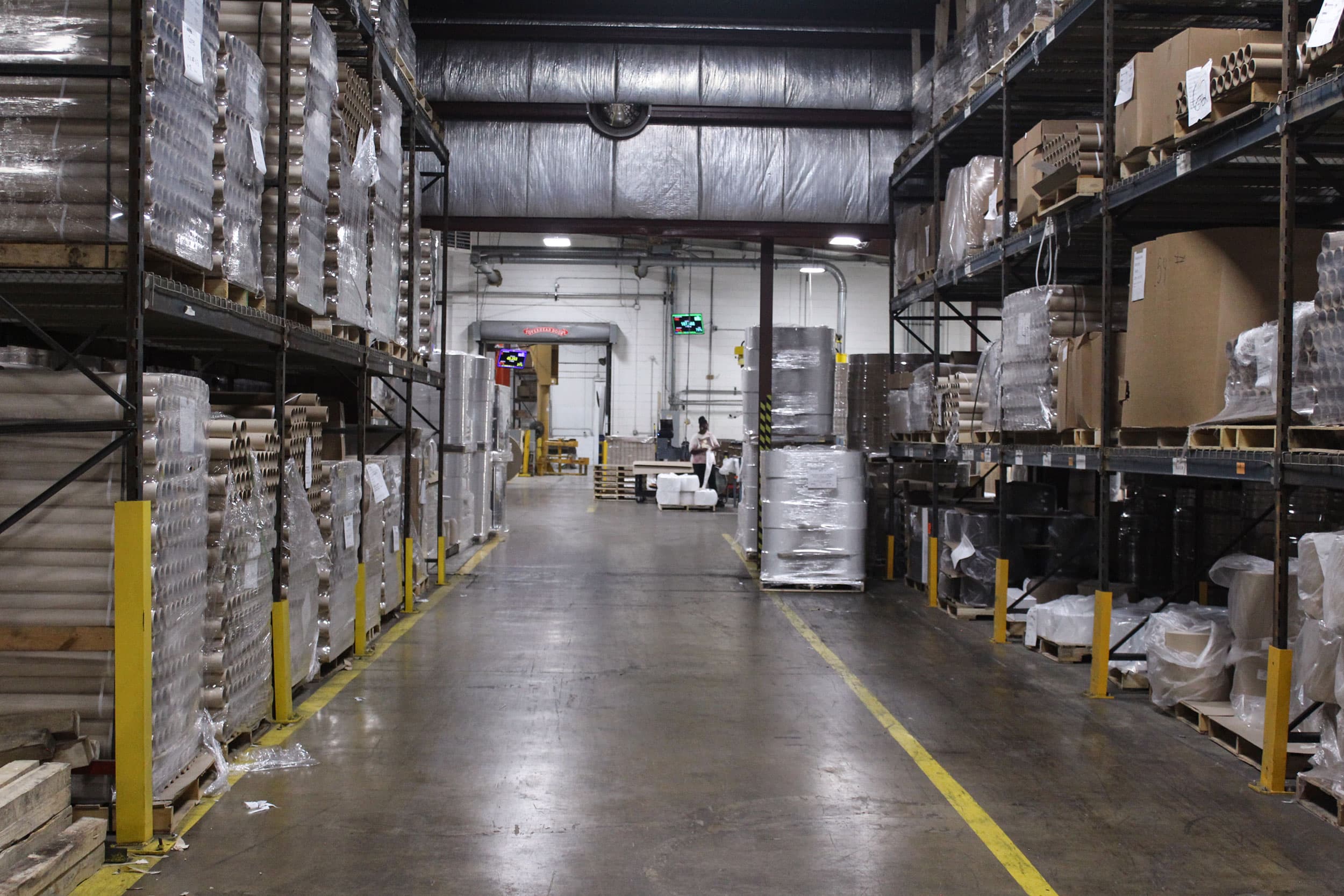 Warehouse aisle with storage racking on both sides at Paper Dimensions